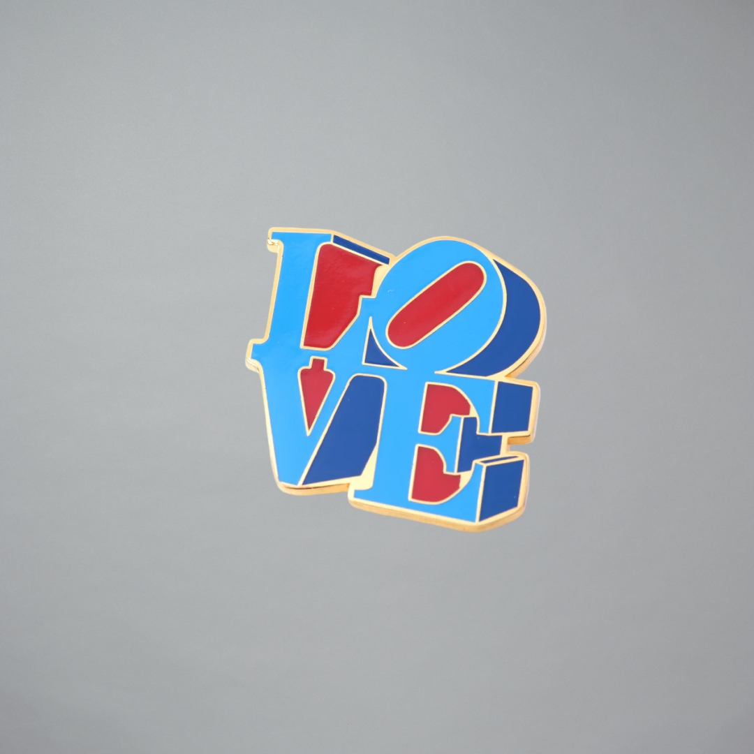 Robert Indiana Love pin on a gray background