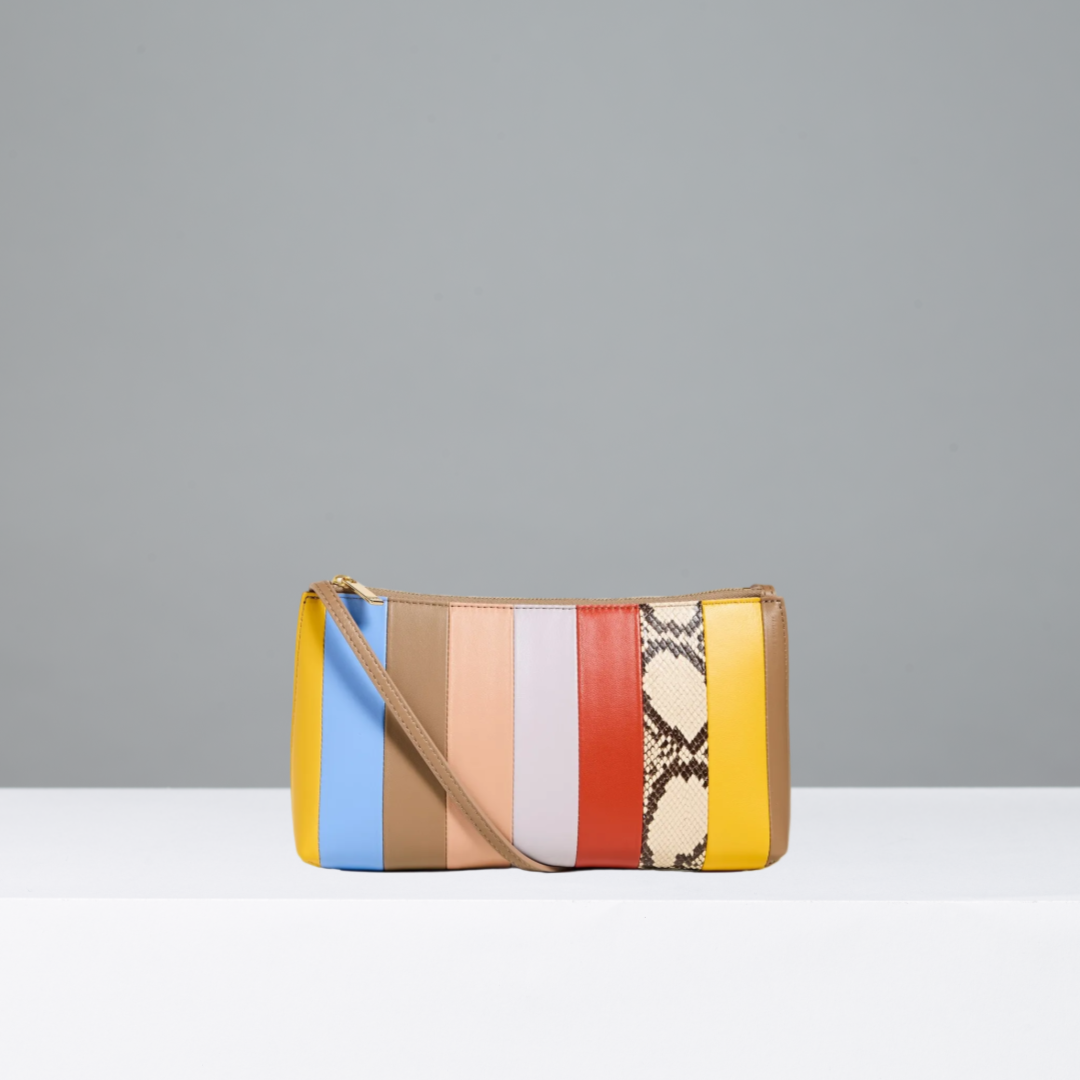 Multicolored striped handbag with a snake skin pattern on a gray background