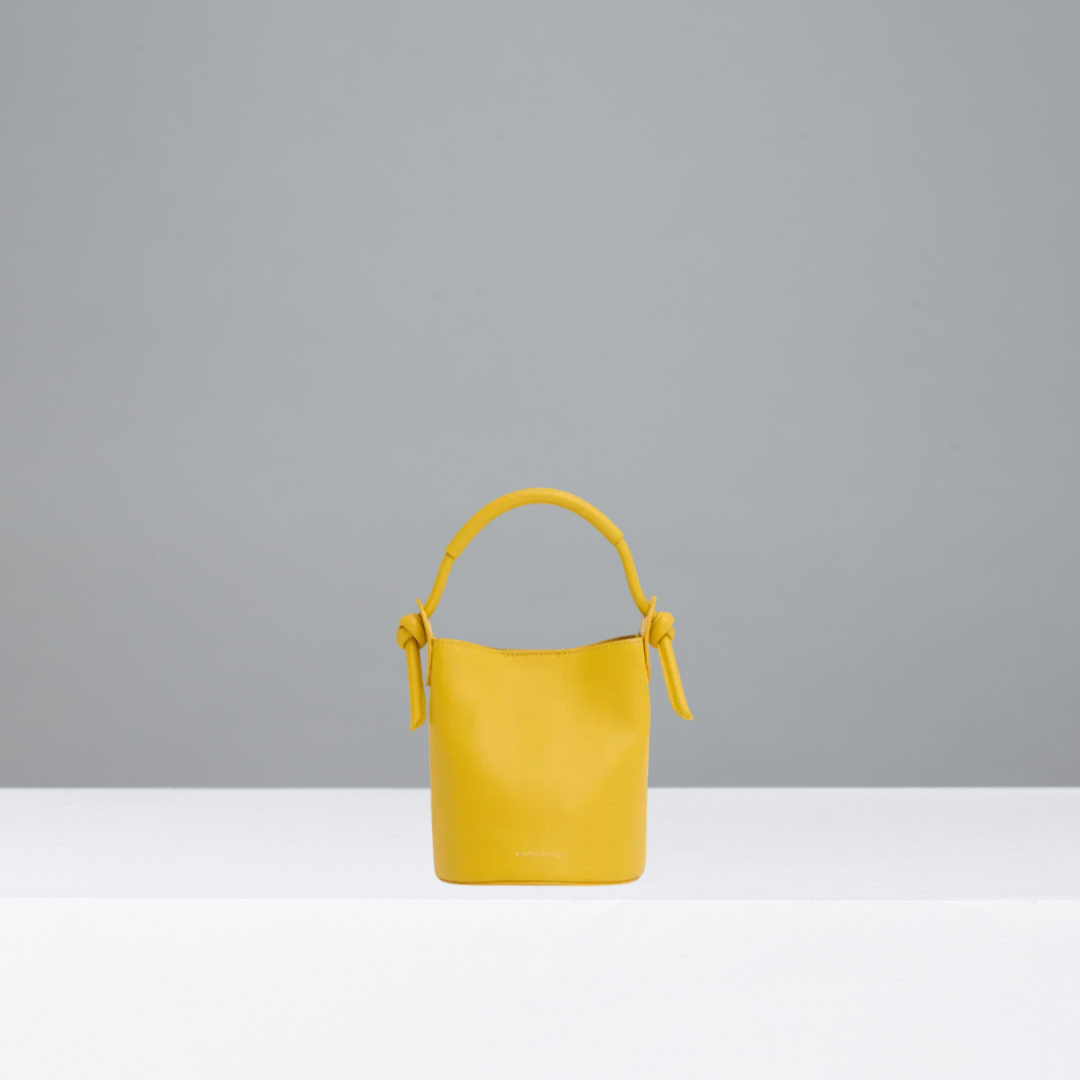 Yellow handbag on a gray background