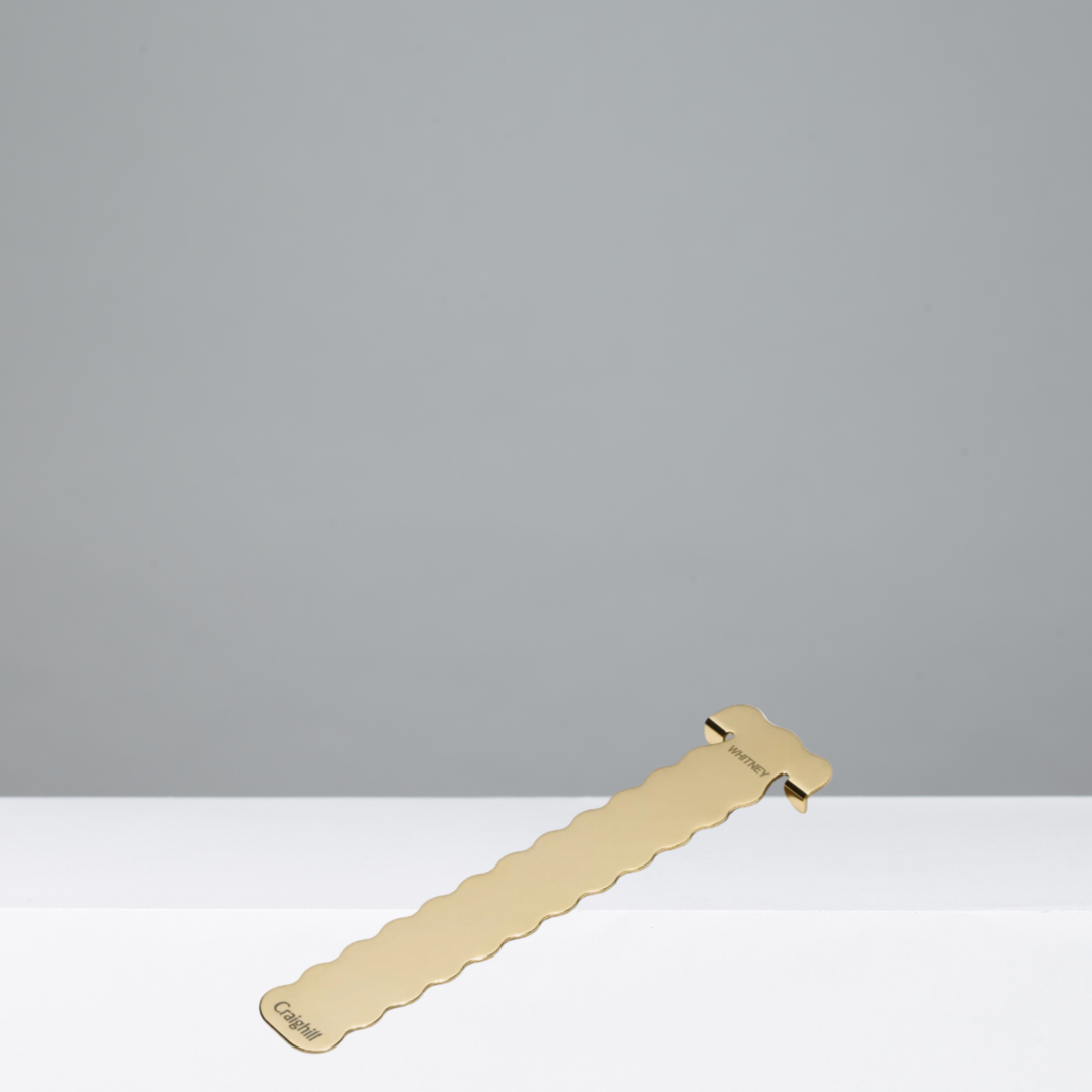 Gold-colored bookmark on a gray background