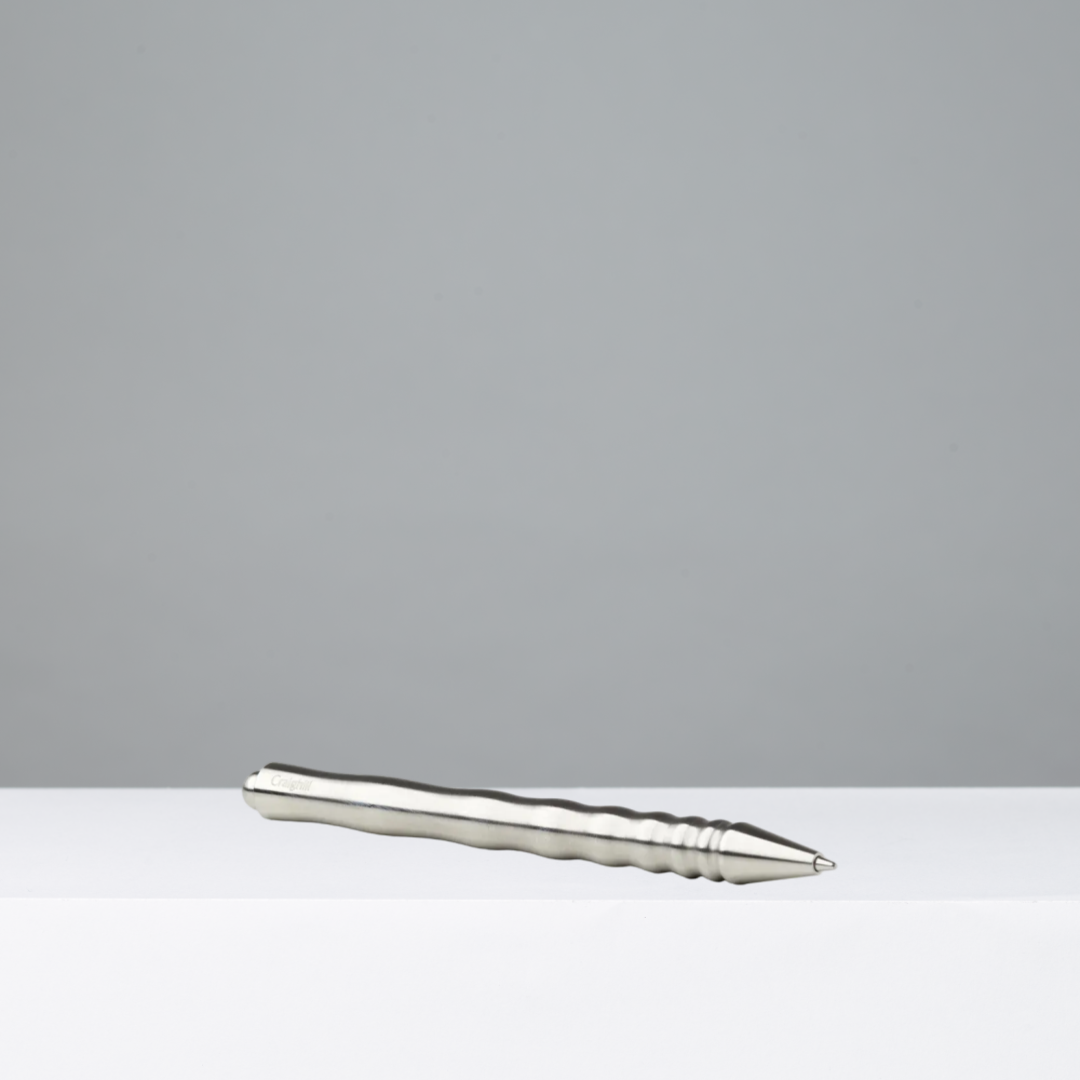 Silver pen on a gray background