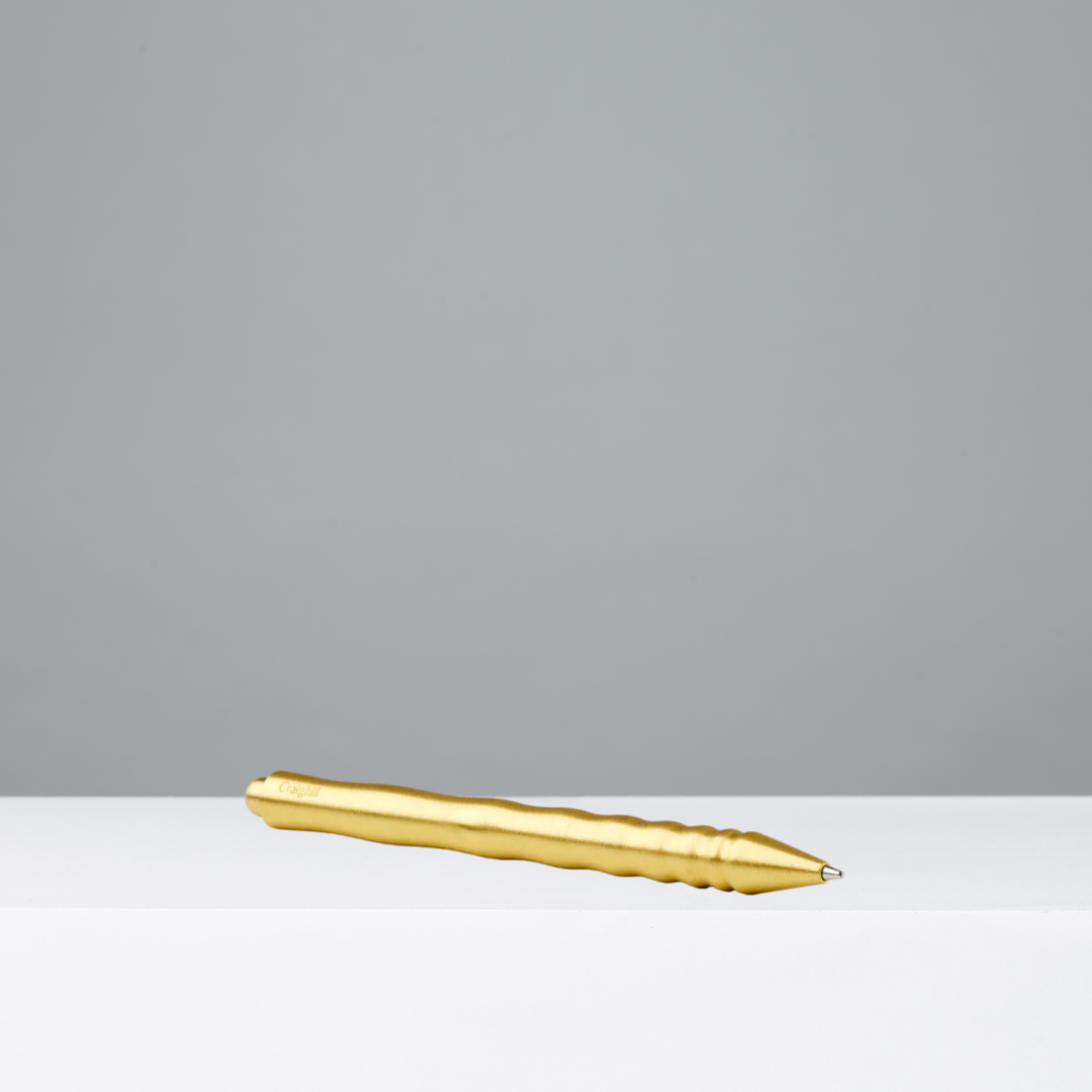 Gold pen on a gray background