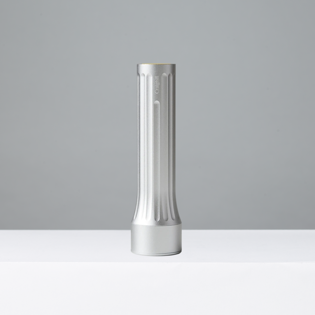 Silver flashlight on a gray background