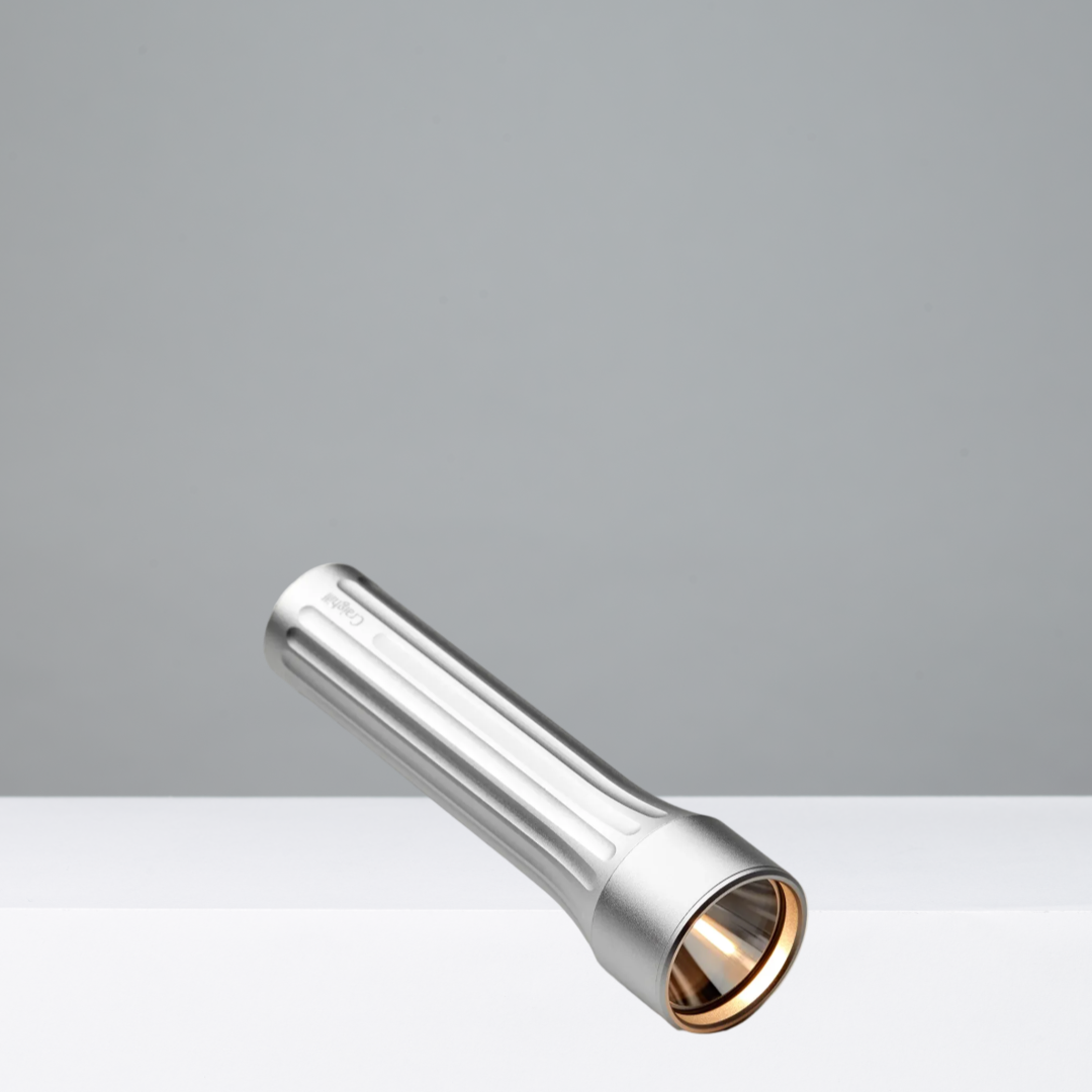 Metallic flashlight on a gray background