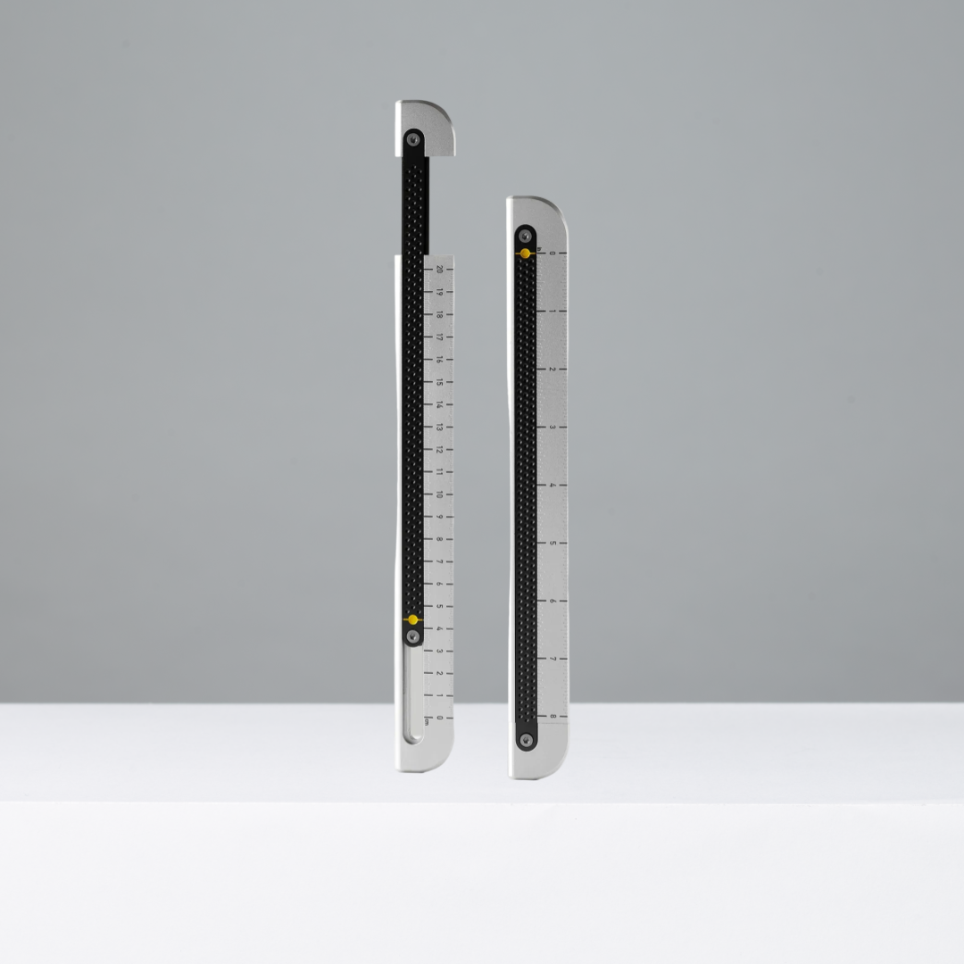 Two metal rulers on a gray background