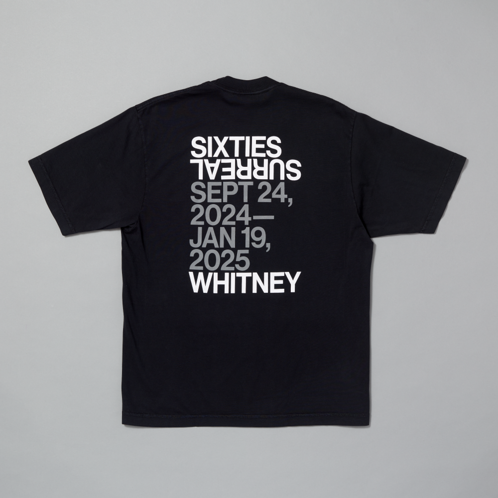 Black t-shirt featuring Sixties Surreal and Whitney in white text and the dates of the exhibit in gray text on a gray background