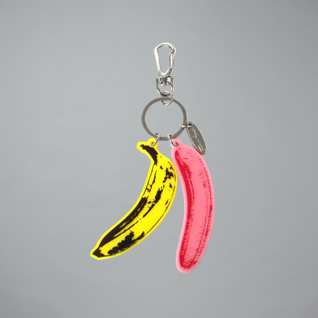 Keychain with yellow banana and pink banana design on a gray background