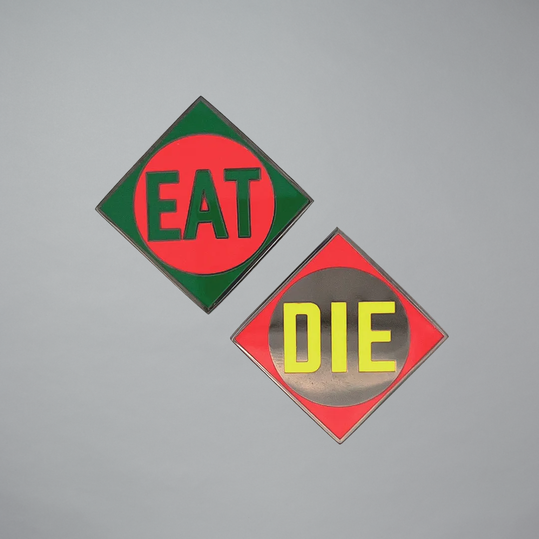 Set of enamel pins featuring EAT and DIE by Robert Indiana