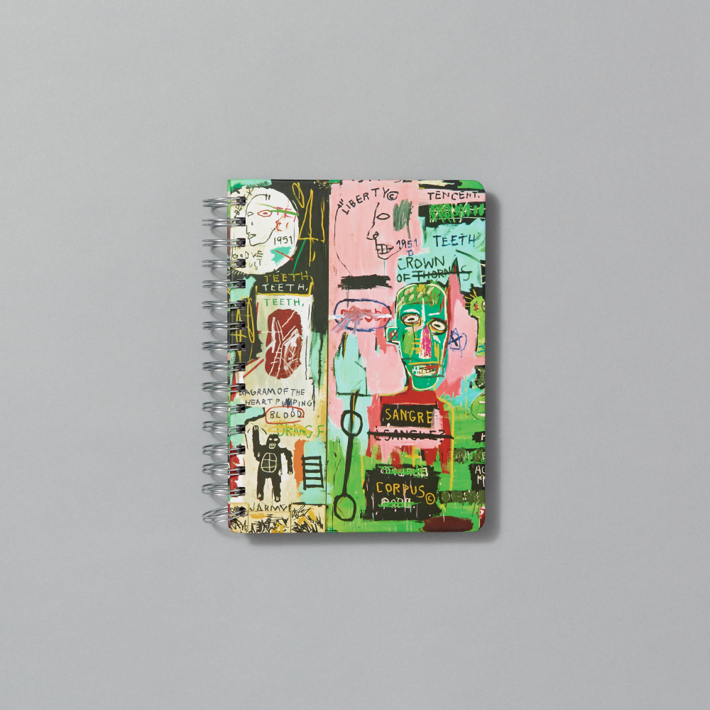 Spiral notebook with Jean-Michel Basquiat's In Italian on a gray background