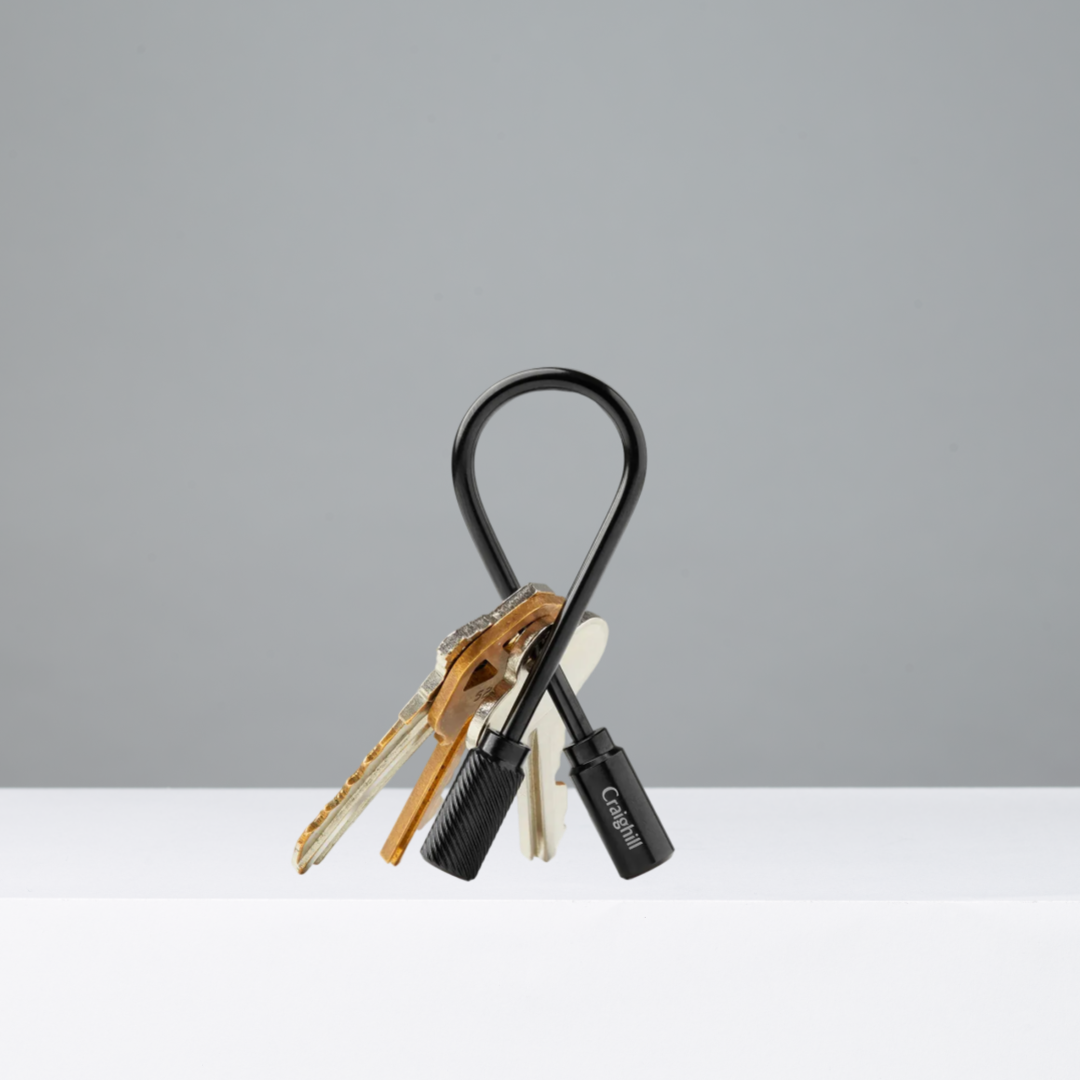 Vapor Black Closed Helix Keyring with keys on a gray background