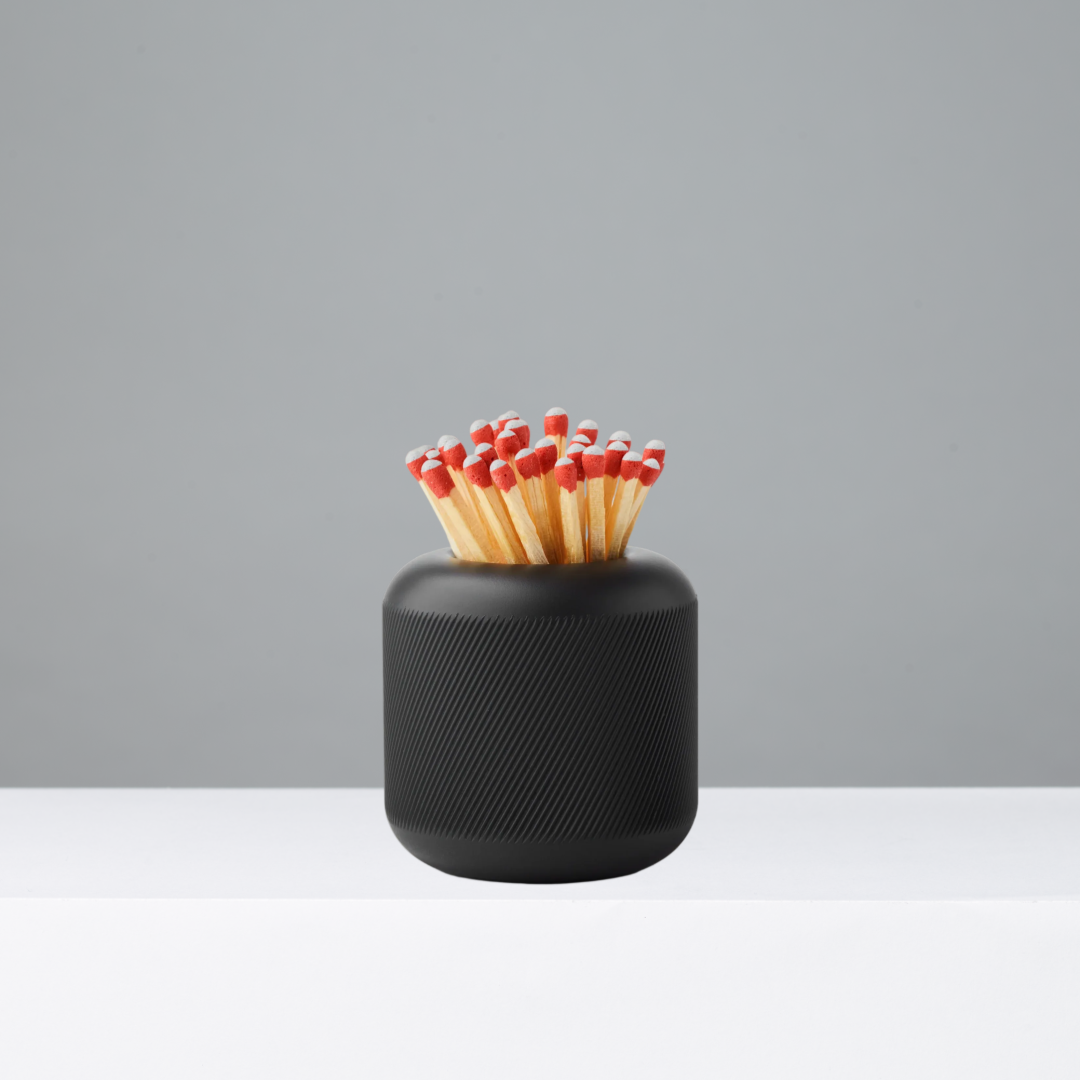 Black Match Striker with matches on a gray background