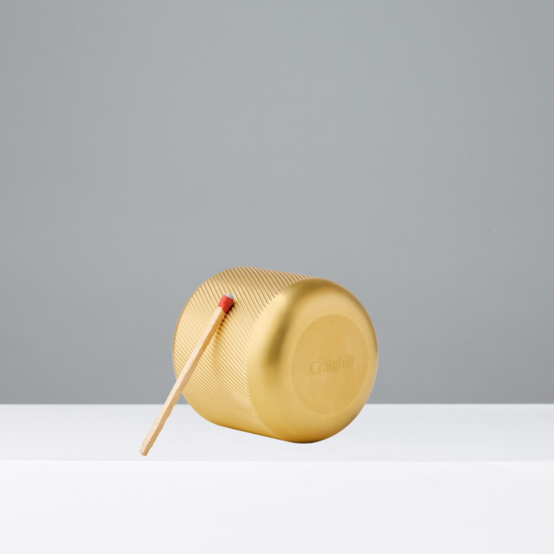 Brass Match Striker with match on a gray background