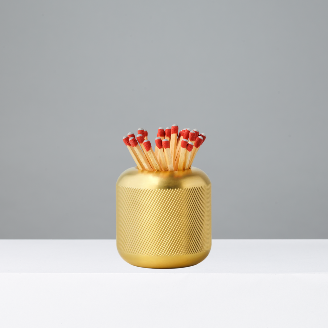 Brass Match Striker with matches on a gray background