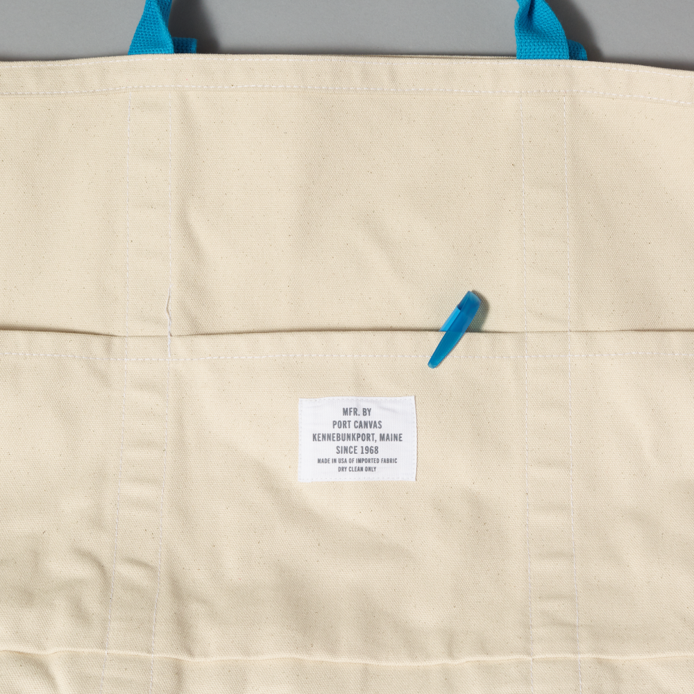 Interior of bag with three pockets against a gray background
