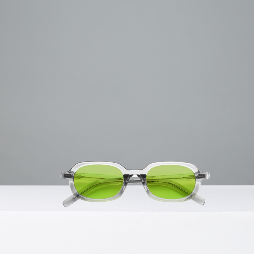 Sunglasses with green lenses on a gray background