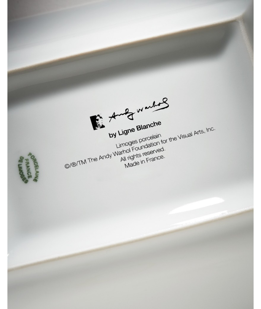Close-up of a Ligne Blanche Andy Warhol porcelain tray with branding and text.