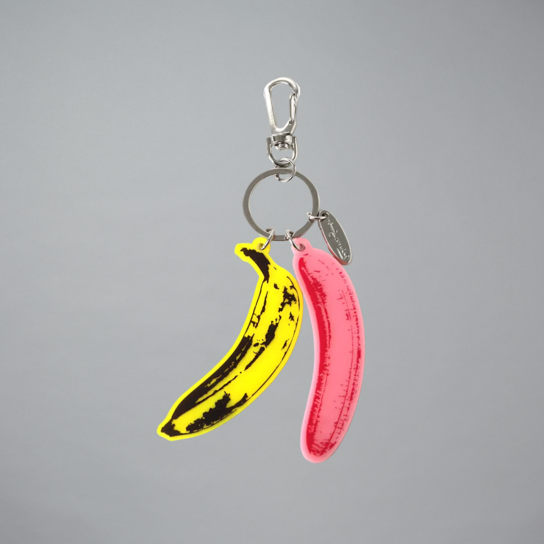 Keychain with yellow and pink banana-shaped charms on a gray background