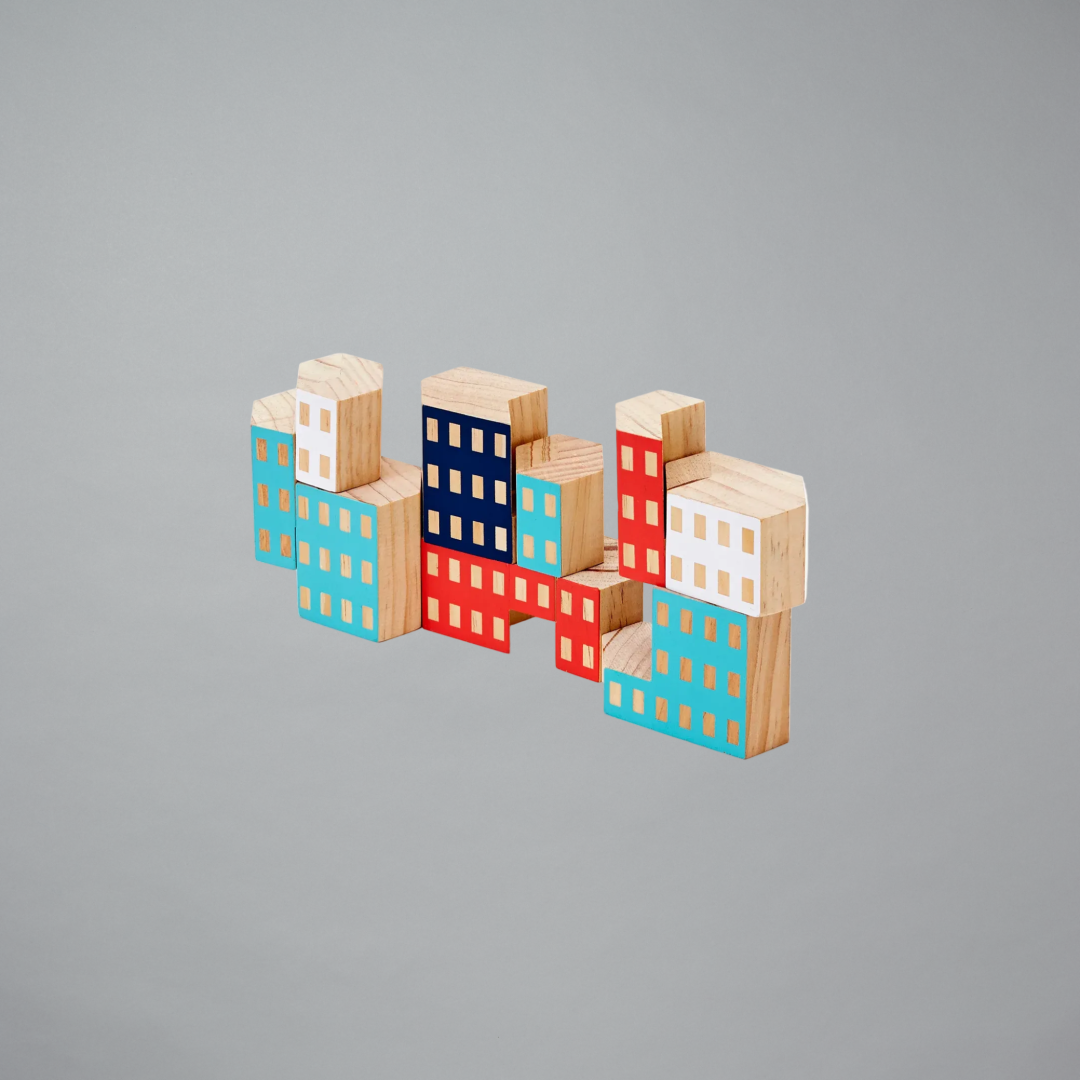 Colorful wooden block city model on a gray background