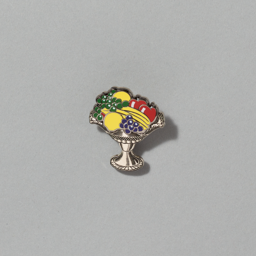 Enamel pin featuring Still Life with Crystal Bowl by Roy Lichtenstein on a gray background