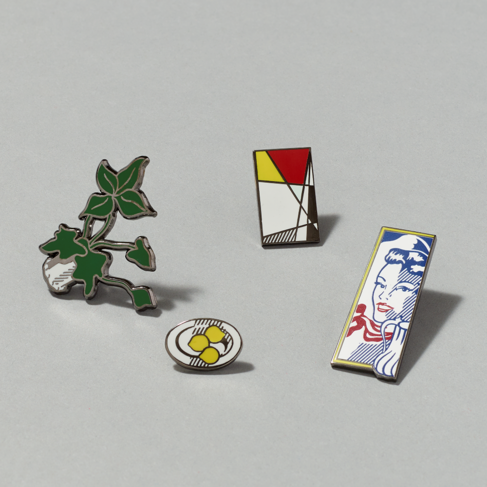 Enamel pin set featuring Artist's Studio, Foot Medication by Roy Lichtenstein on a gray background