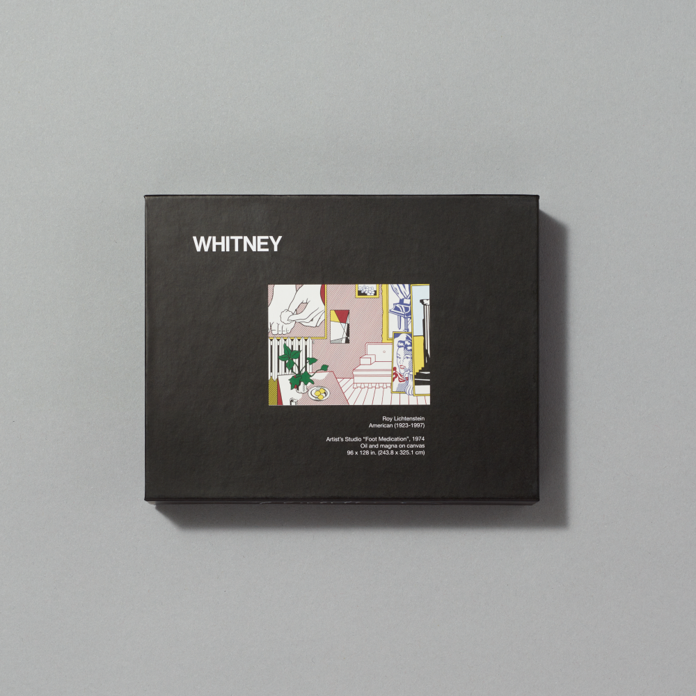 Enamel pin set featuring Artist's Studio, Foot Medication by Roy Lichtenstein in a black gift box on a gray background