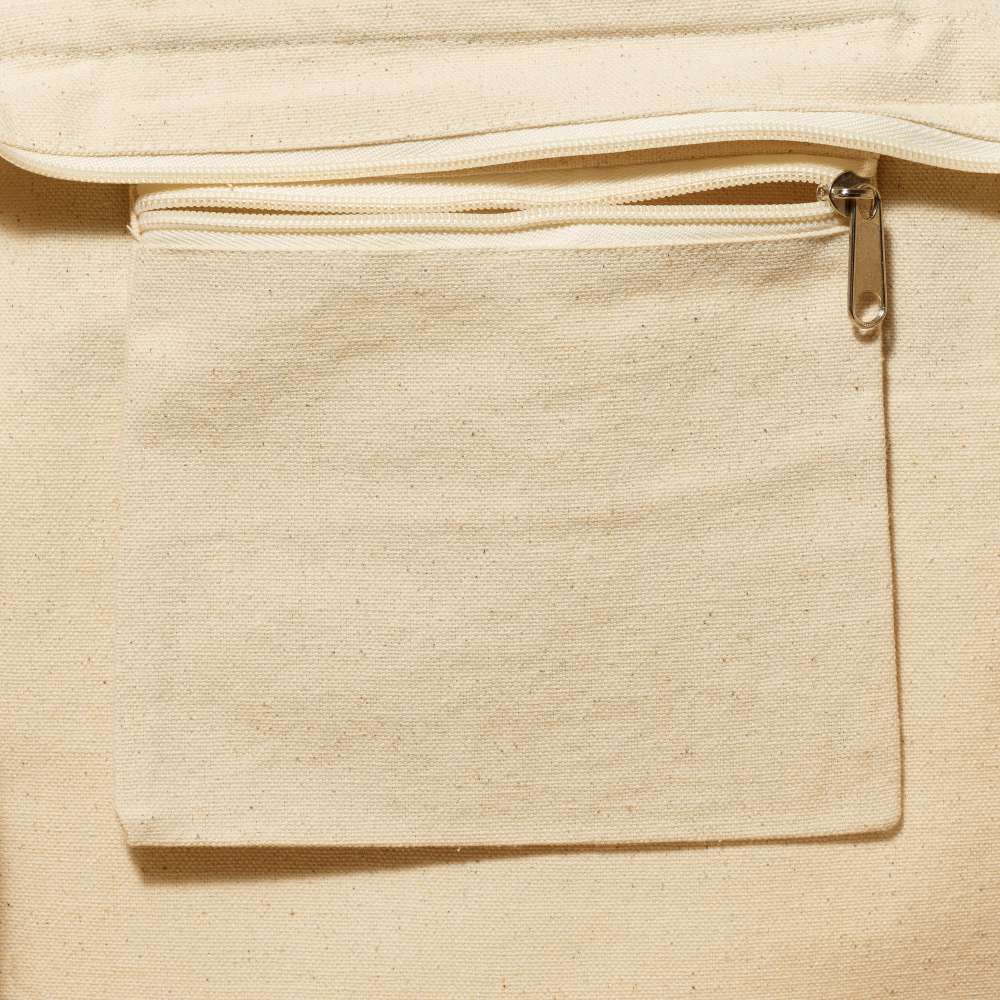 Close up of beige canvas pocket with zipper detail