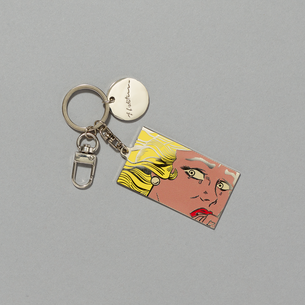 Silver plated enamel brass keychain featuring Roy Lichtenstein's Crying Girl against a gray background