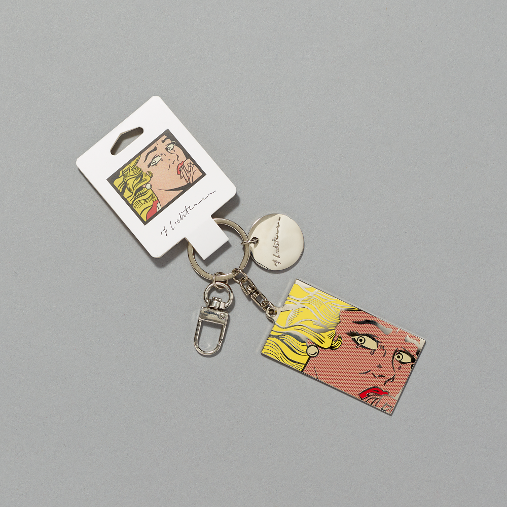 Silver plated enamel brass keychain featuring Roy Lichtenstein's Crying Girl against a gray background