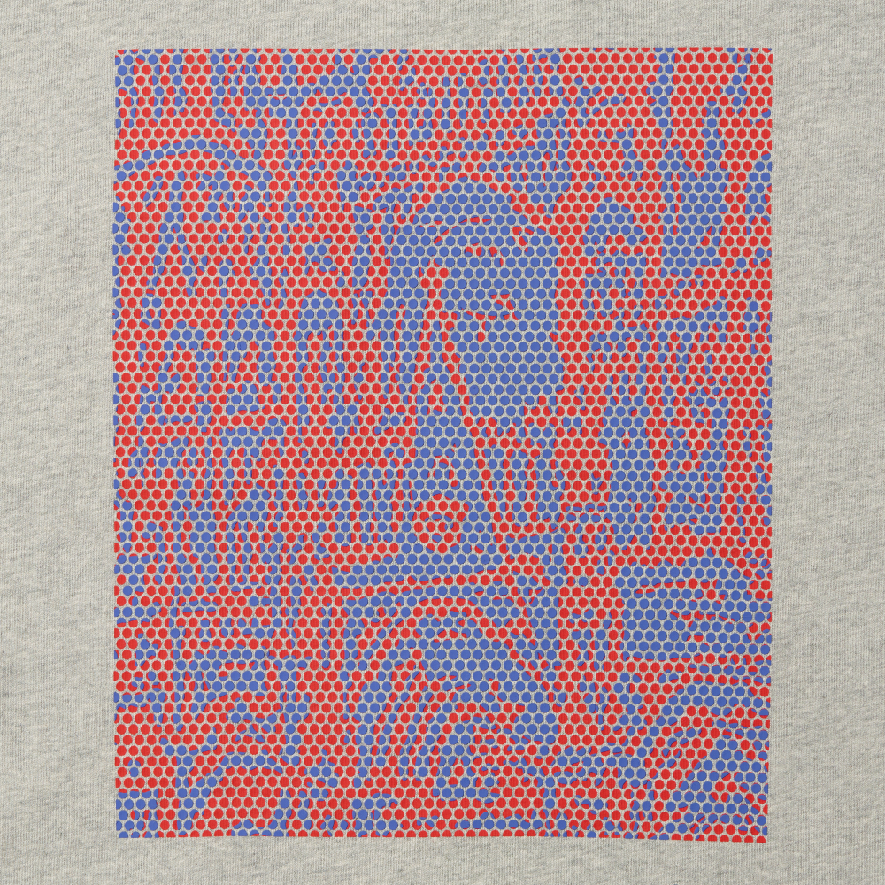 A close-up graphic print featuring an abstract pattern of red and blue hexagonal dots inspired by Roy Lichtenstein's work Cathedral #2 on a gray long sleeve t-shirt