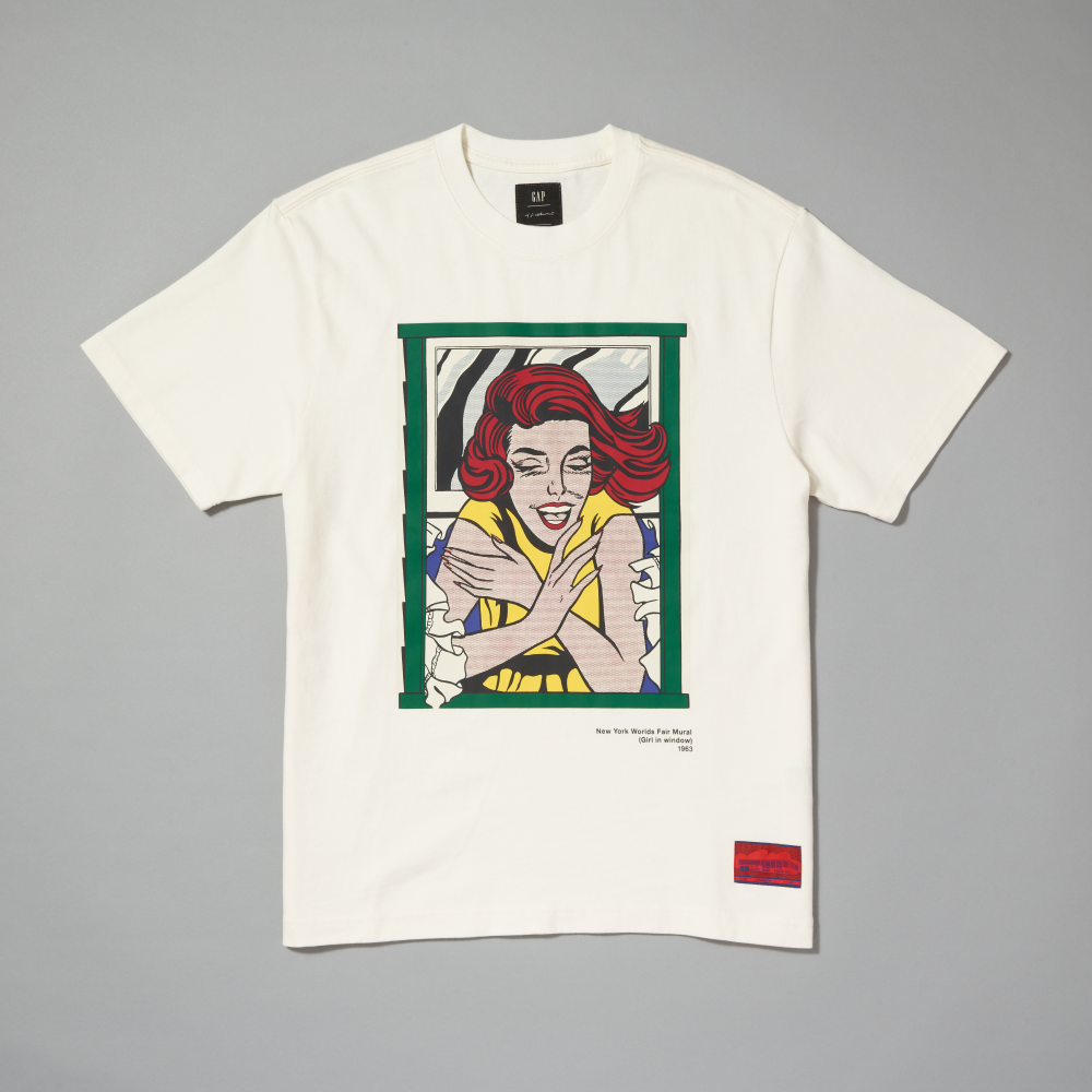 An off-white short-sleeve t-shirt with a graphic print featuring Roy Lichtenstein's Girl in Window displayed flat against a neutral gray background