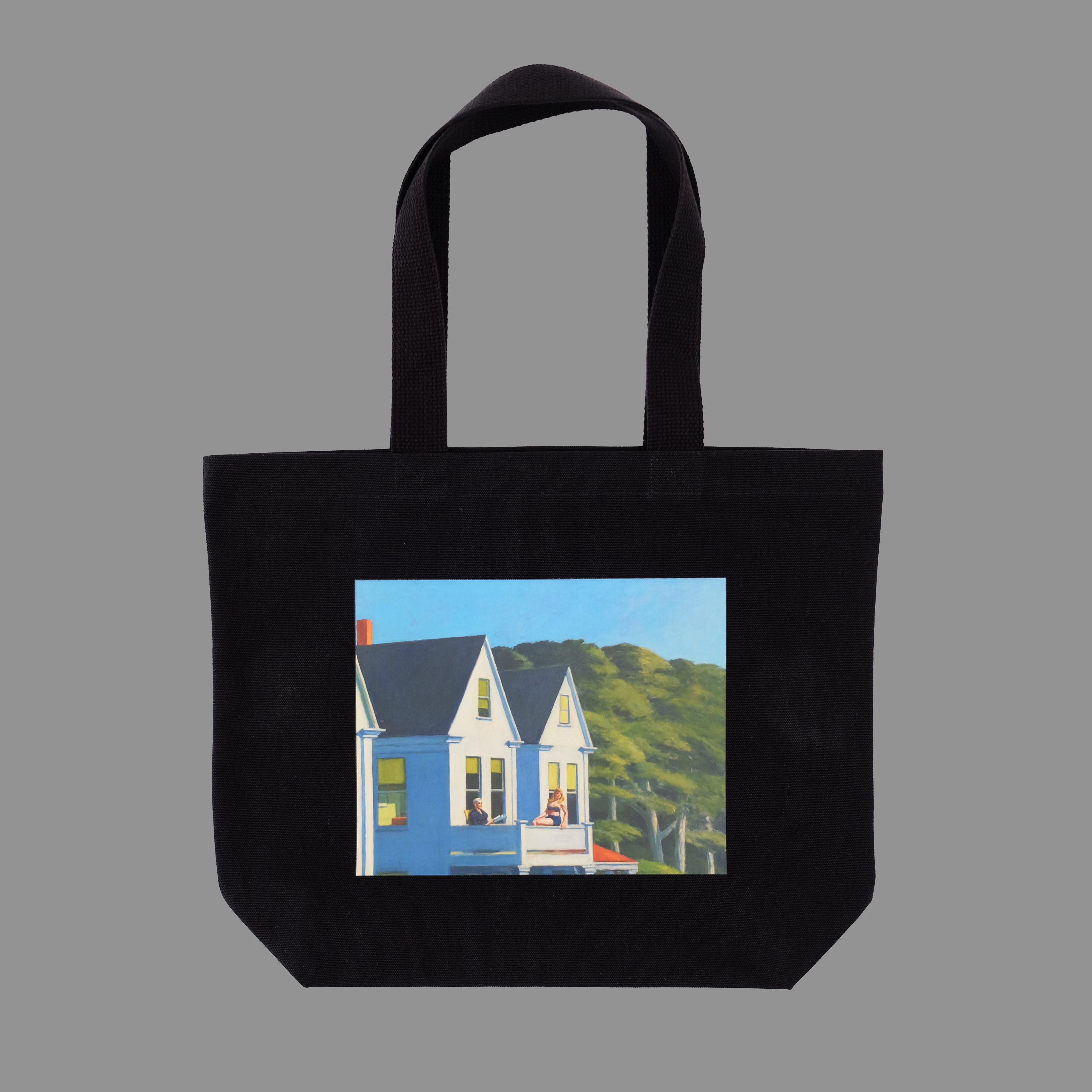 Black tote bag with a printed design of Edward Hopper's Second Story Sunlight a gray background