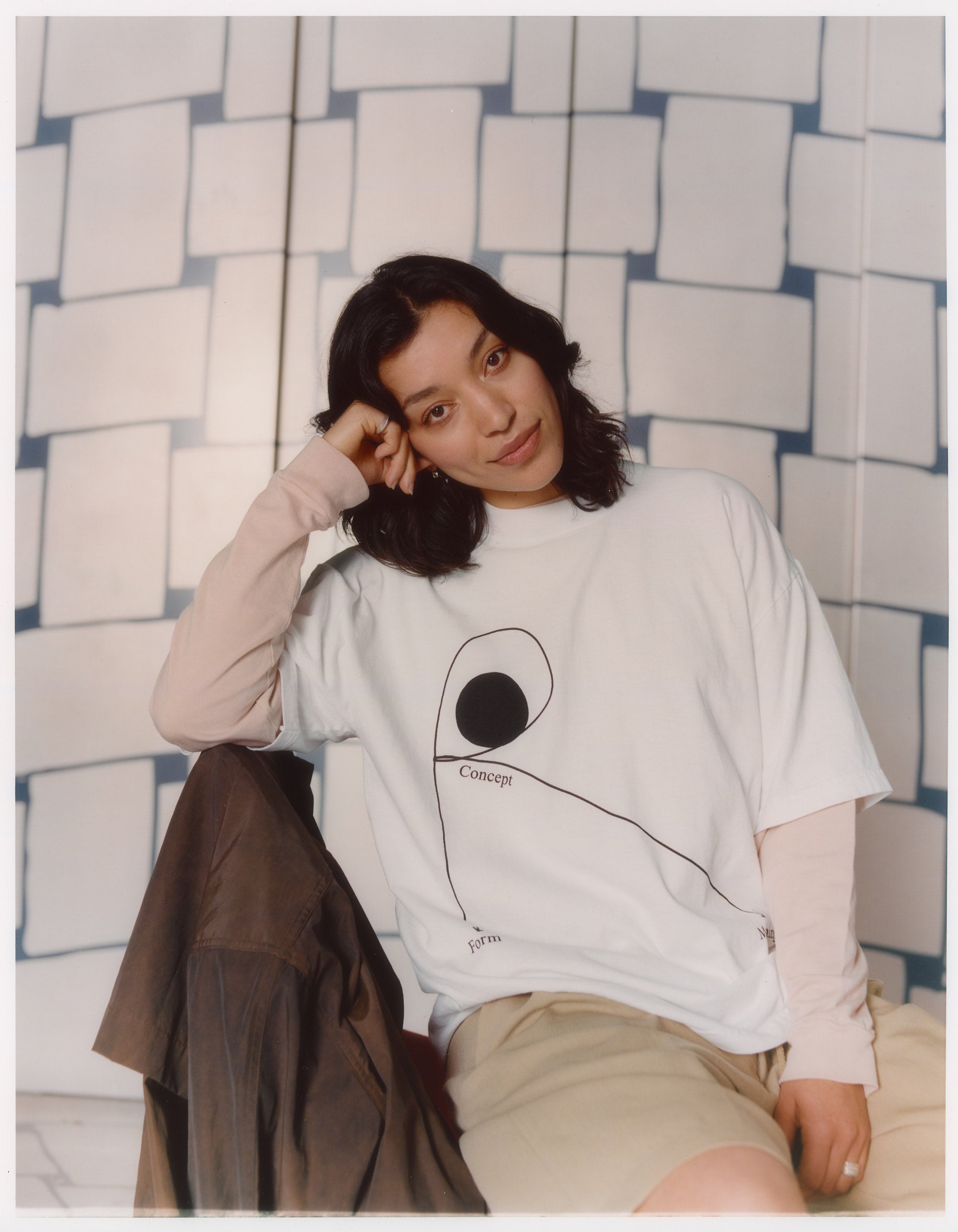 Model wearing 100% cotton white t-shirt featuring a graphic in black by Public Records