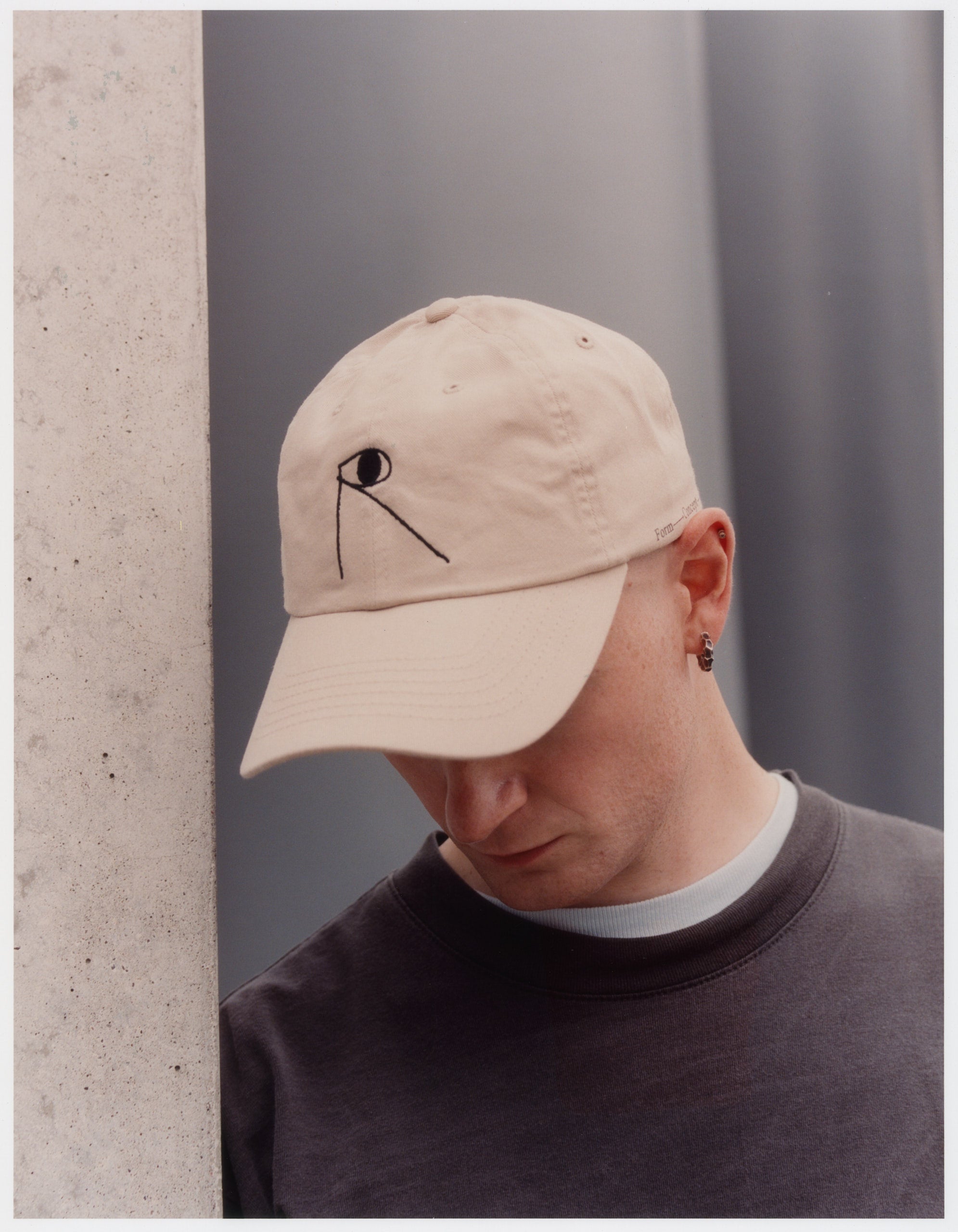 Model wearing 100% cotton beige cap with the Public Records logo in black