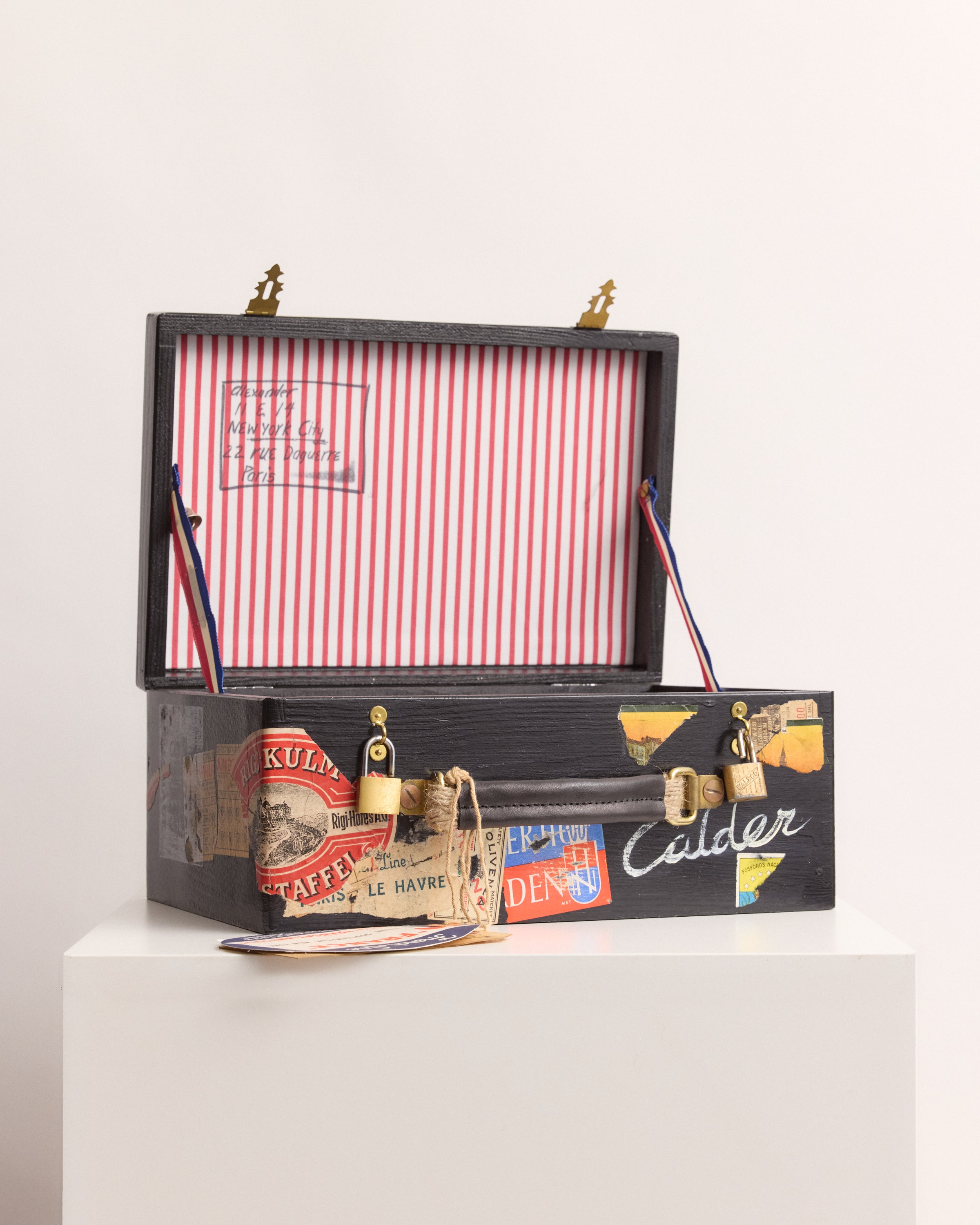 Decorative suitcase box with vintage-style packaging on a white background