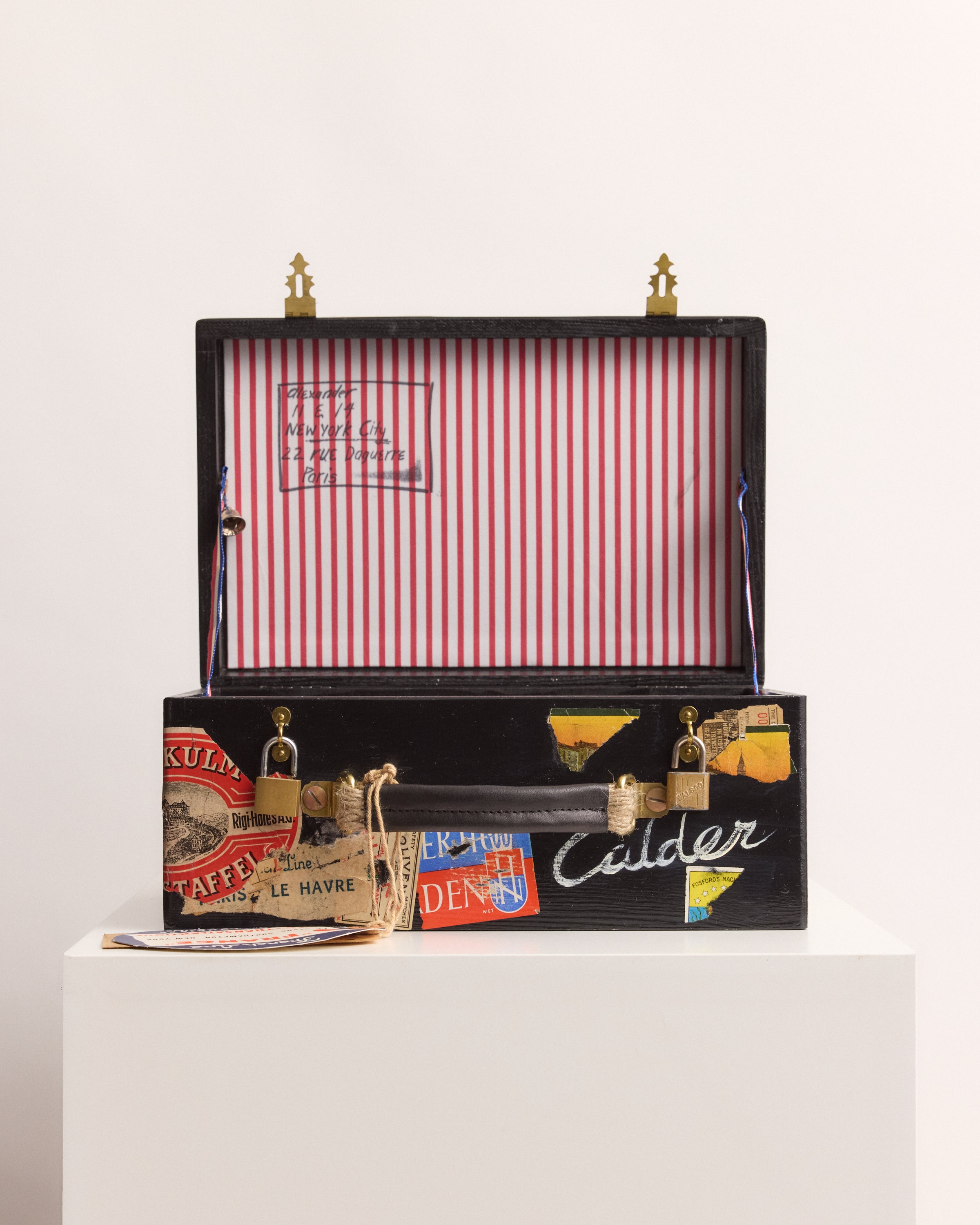 Decorative suitcase box with vintage label design on a white background