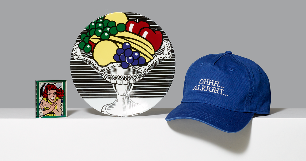 Assortment of Roy Lichtenstein inspired products including a magnet, porcelain plate and blue baseball hat with Ohhh... Alright... embroidered in white