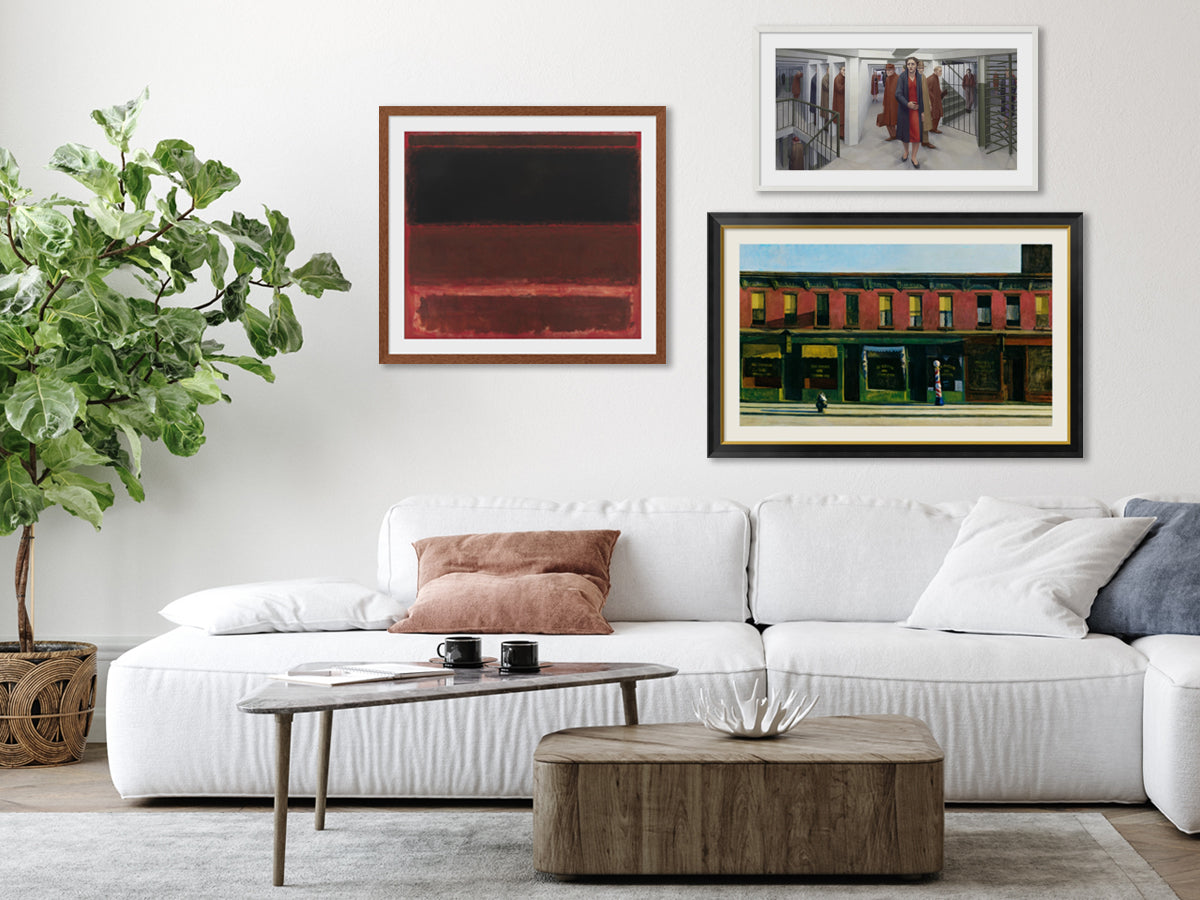 Living room with a white sofa, coffee table, and wall art